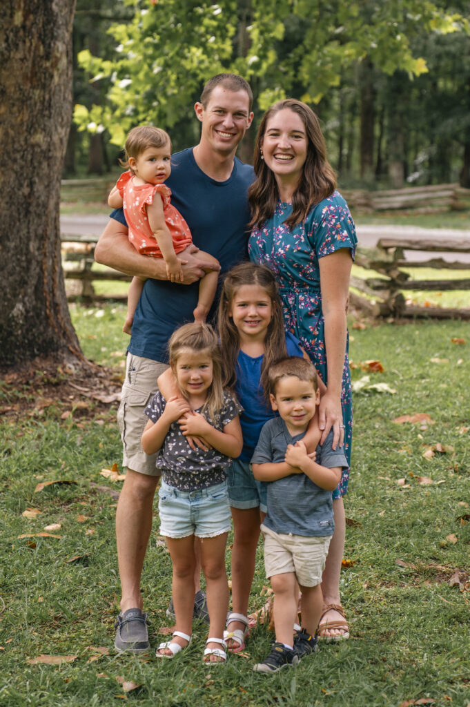 Family standing together outdoors smiling 