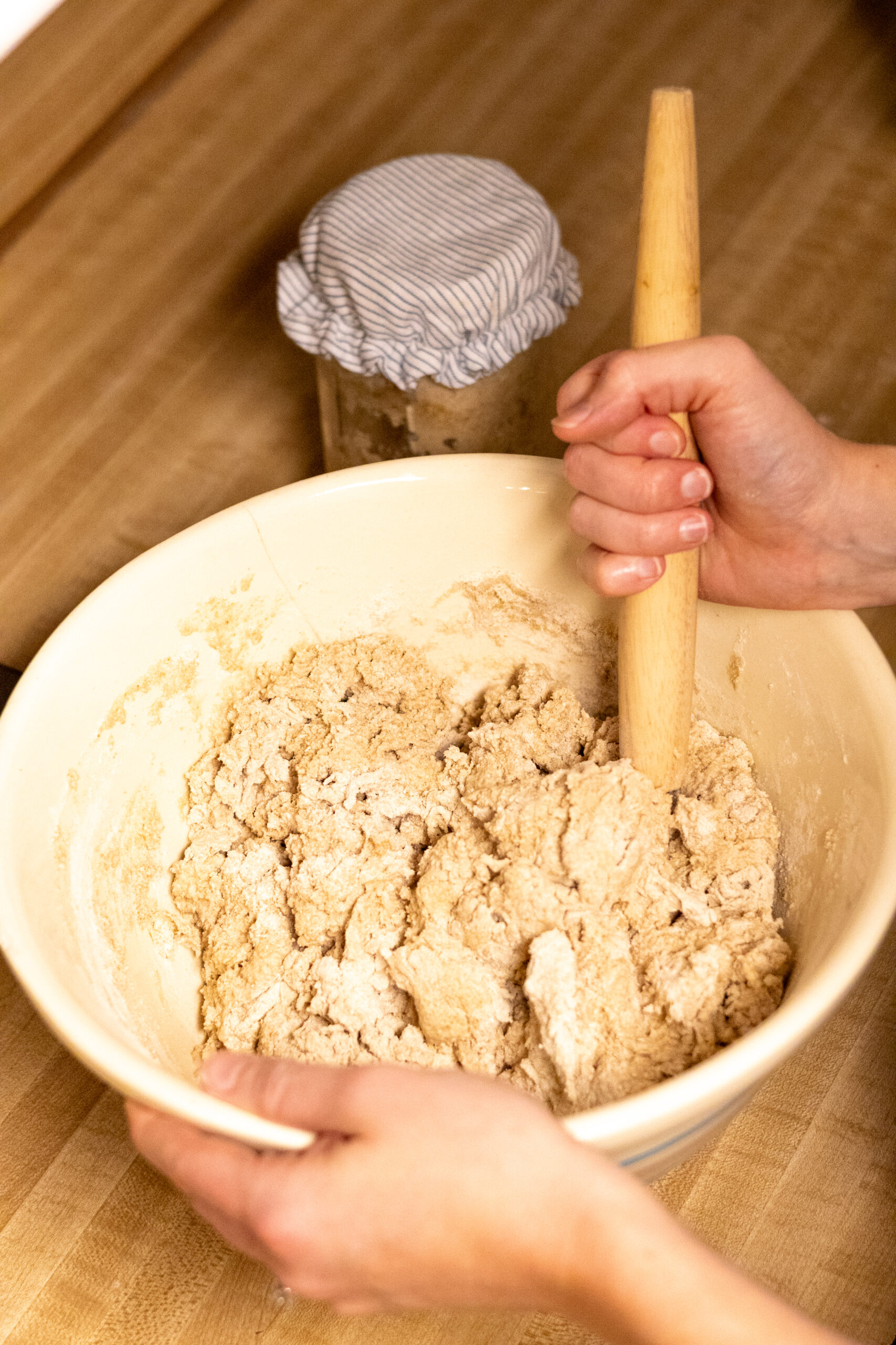 Using a danish dough whisk to combine ingredients for freshly milled artisan sourdough bread