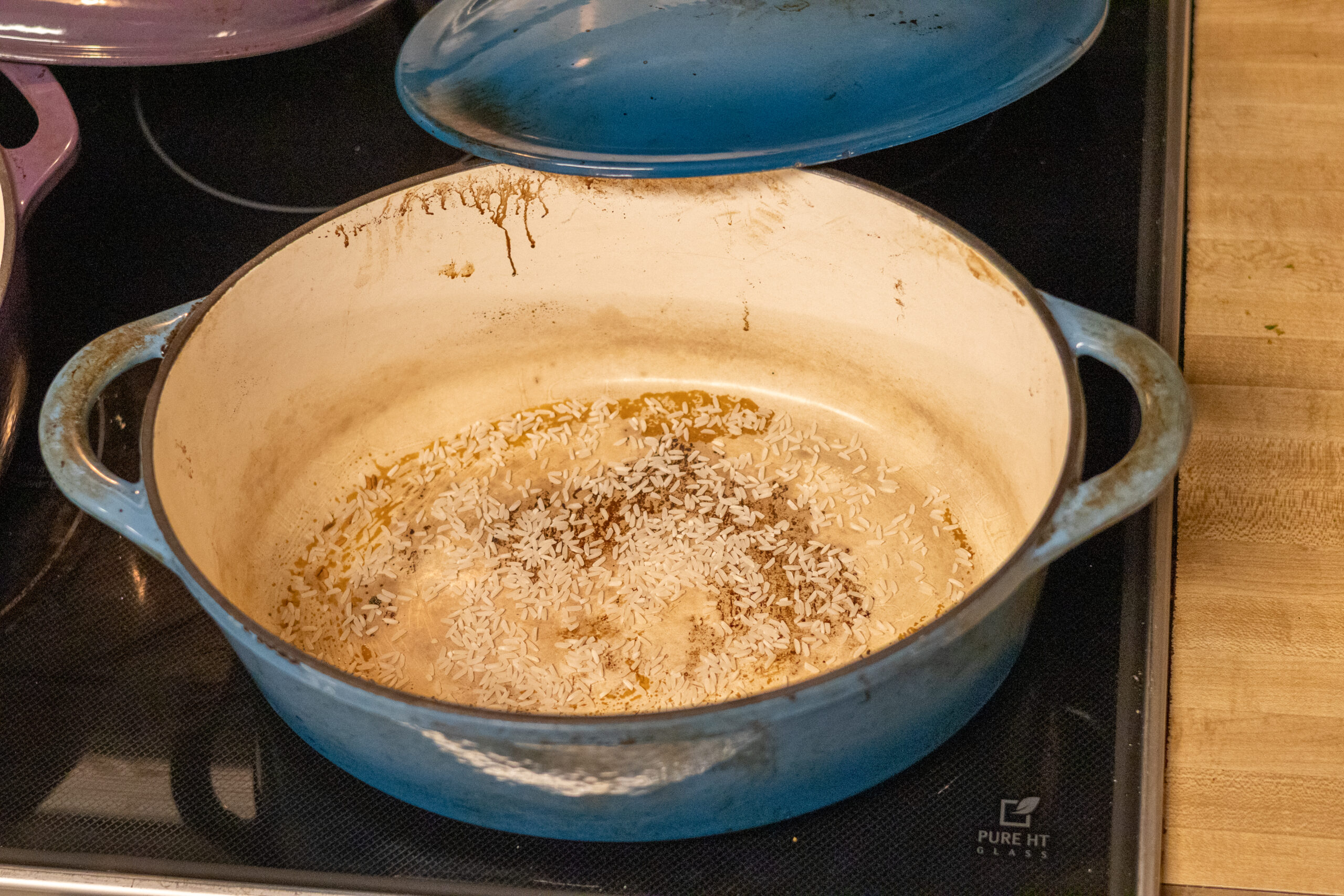 Open dutch oven on the stove top ready to place bread dough inside