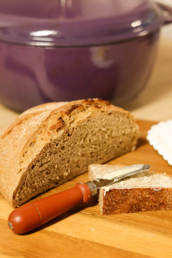 Freshly milled artisan loaf of sourdough bread on cutting board